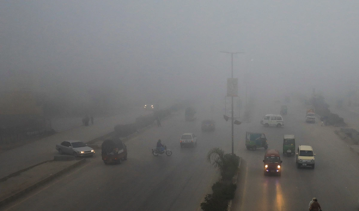 Vehicles move amid fog during morning hours in Peshawar, Pakistan on December 22, 2022. (REUTERS)