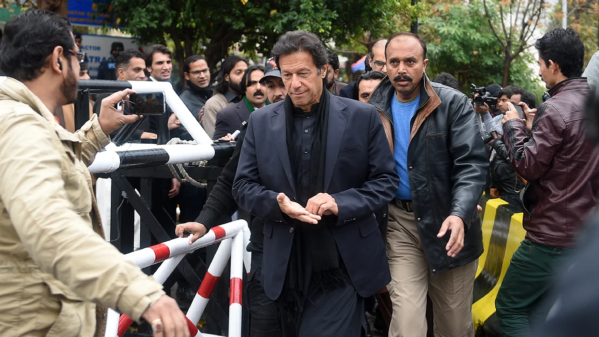 In this file photo taken on January 4, 2017, Pakistan's for prime minister Imran Khan (C) walks with officials as he leaves The Supreme Court in Islamabad. (Photo courtesy: AFP/File)