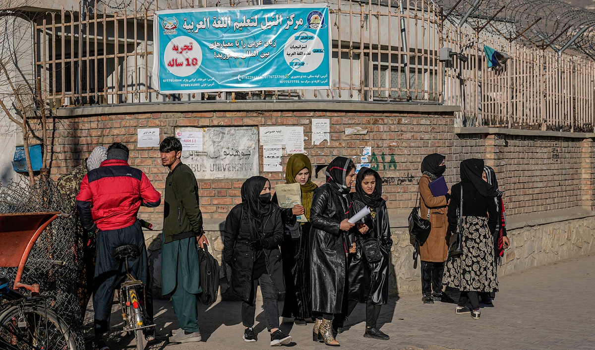 Afghan women students stand outside the Kabul University in Kabul, Afghanistan, on December 21, 2022. (AP)