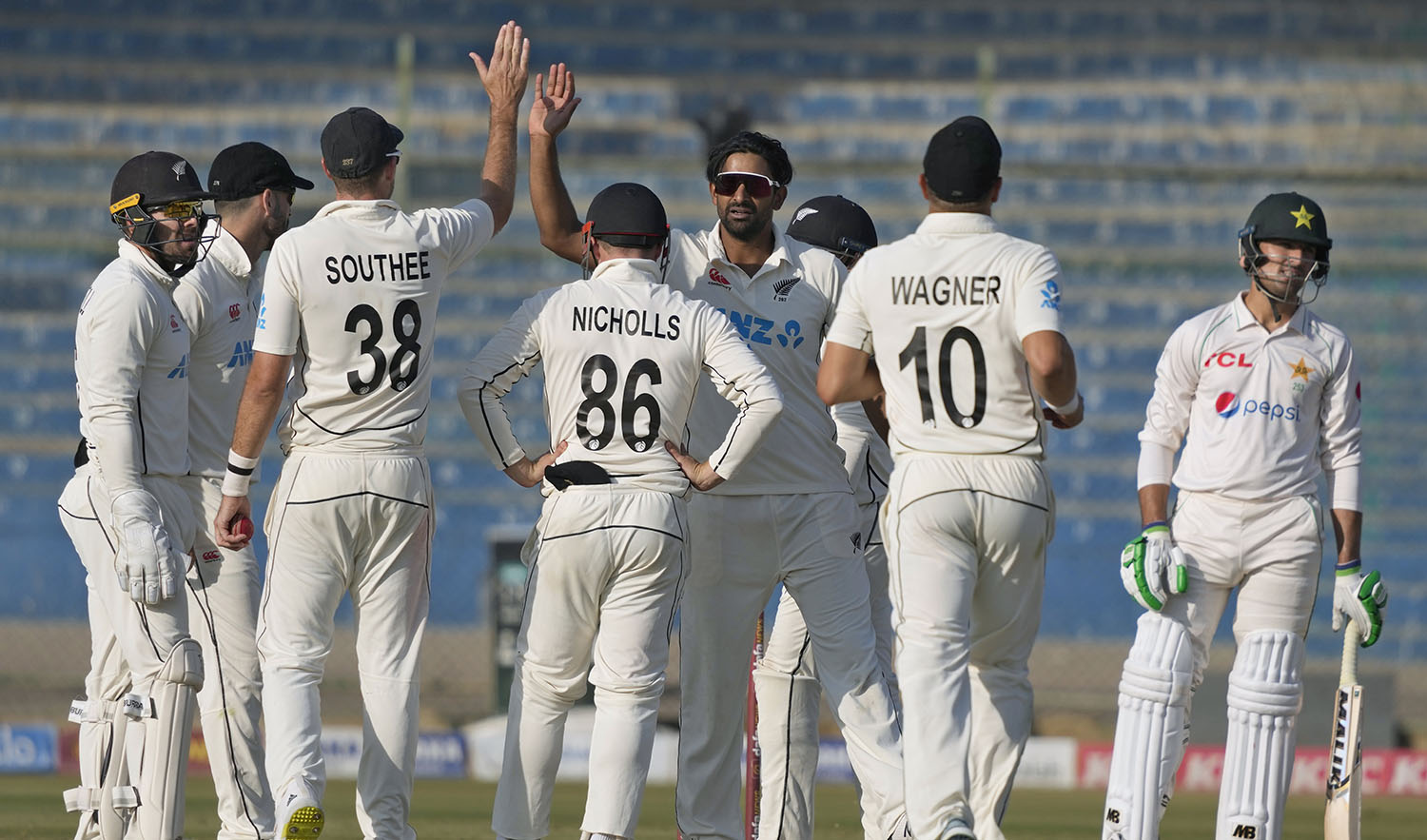 New Zealand's Ish Sodhi, center, celebrates with teammates after taking the wicket of Pakistan's Mohammad Wasim, right, during the fifth day of first test cricket match between both teams, in Karachi, Pakistan, on December 30, 2022. (AP)