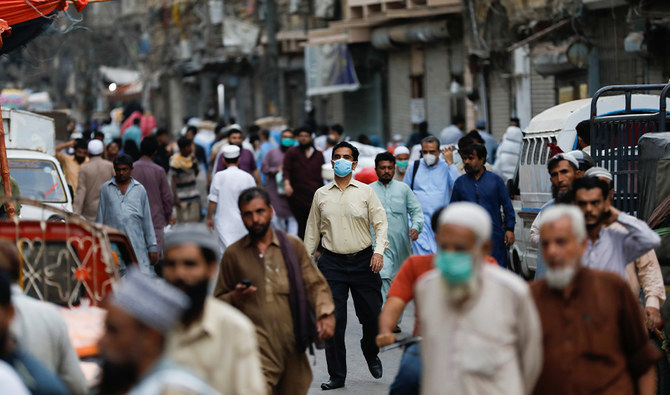 A man wears a protective face mask as he walks among other people along a street, as the outbreak of the coronavirus disease (COVID-19) continues, in Karachi, Pakistan June 16, 2020. (REUTERS/FILE)