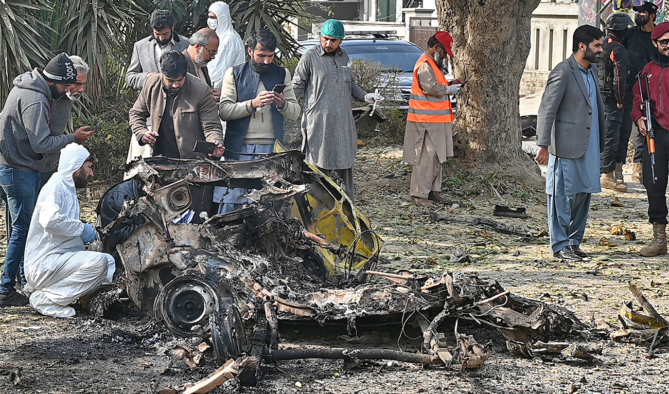 Policemen collect evidence at the suicide blast site in Islamabad, Pakistan, on December 23, 2022. (AFP)