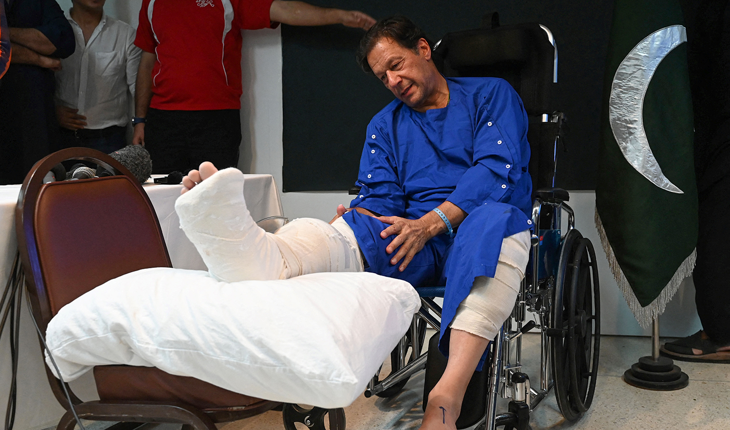 Pakistan's former Prime Minister Imran Khan speaks with media representatives at a hospital in Lahore on November 4, 2022, a day after an assassination attempt on him during his long march near Wazirabad. (AFP/File)