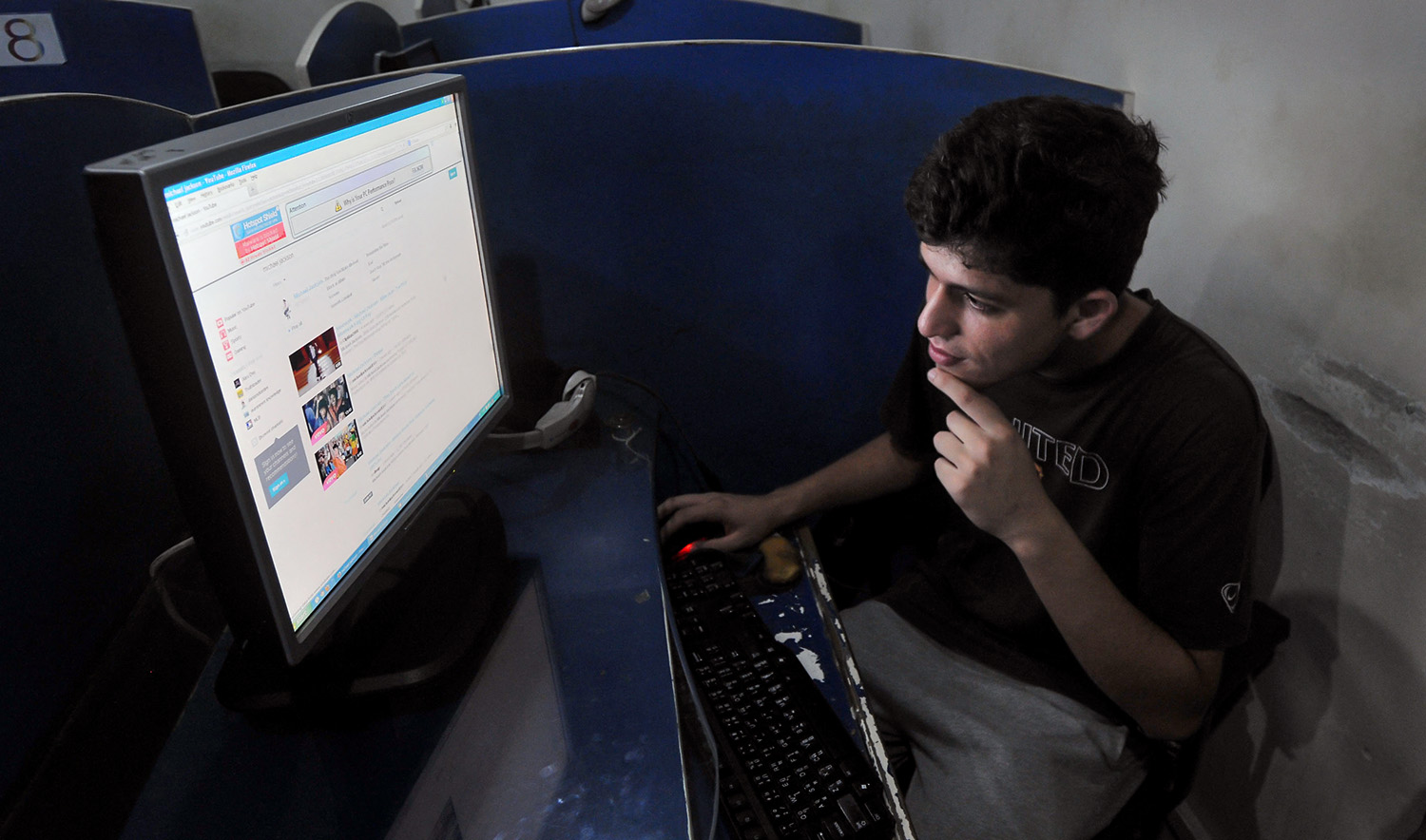 A Pakistani student is seen using one of the computers at an internet cafe in Lahore on September 9, 2013. (AFP/File)