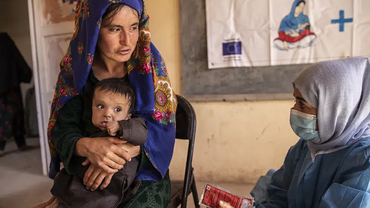 This file photo taken on September 29, 2022, shows a nutrition counselor (right) talking to an Afghan woman in Sar-e-Pul province of Afghanistan. (Photo courtesy: AP via Save the Children)
