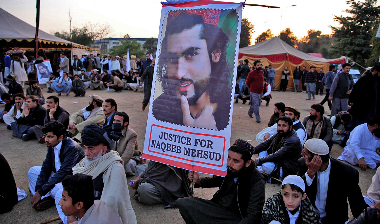A member of the Pashtun community holds a picture of Naqibullah Mehsud, whose extrajudicial killing by Karachi police sparked nationwide protests, as he gathers with others to protest against what they say are enforced “disappearances” and routine oppression, in Islamabad, Pakistan on February 1, 2018. (REUTERS/File)
