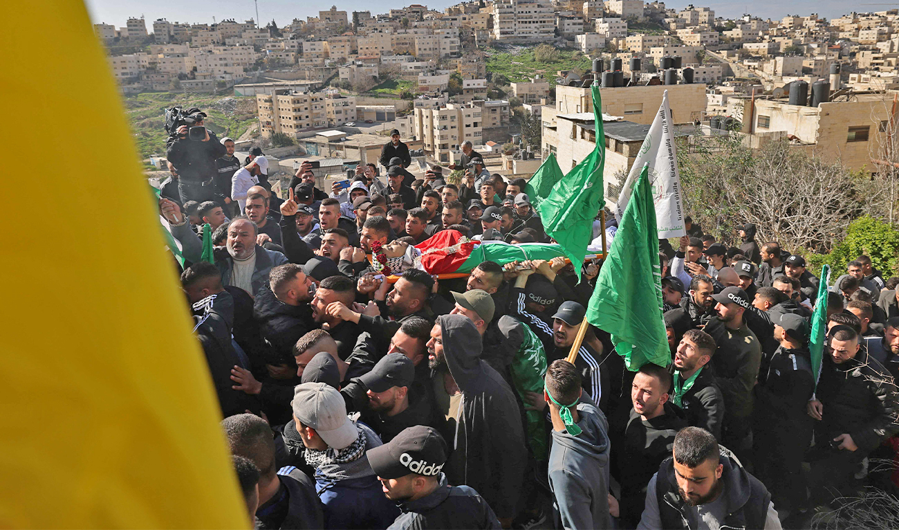 Mourners carry the body of Palestinian youth Yusef Muhaisen, killed by Israeli fire amid clashes, during his funeral in the West Bank town of Al-Ram on January 27, 2023. (AFP)