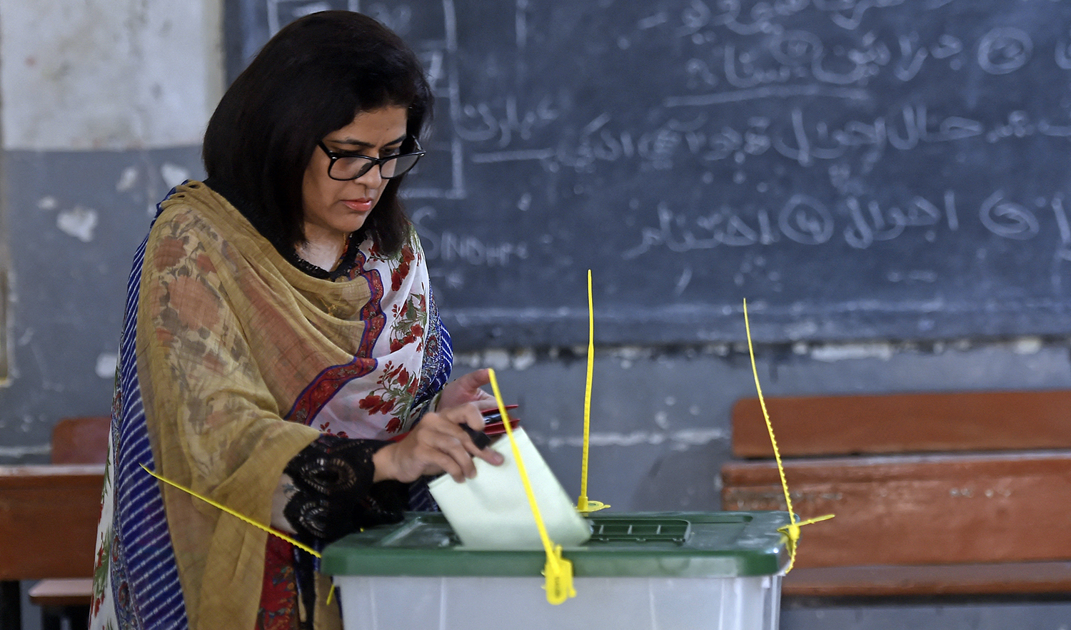 A female voter casts her ballot at a polling station during the by-election for national assembly seats, in Karachi, Pakistan, on October 16, 2022. (AFP/File)