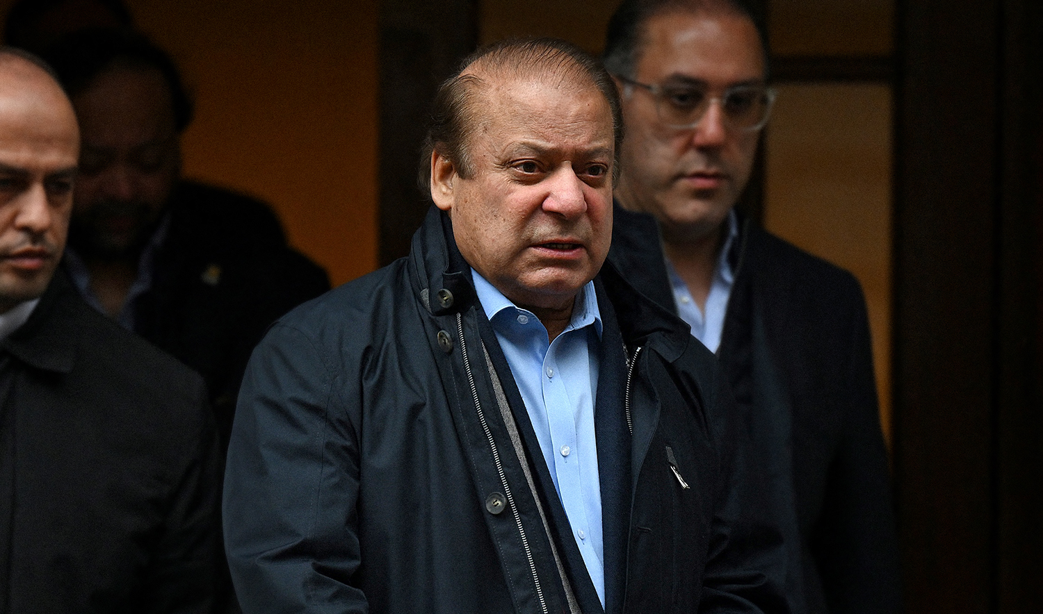 Pakistan's former Prime Minister Nawaz Sharif, third left, leaves from a property in west London, United Kingdom, on May 11, 2022. (AFP/File)