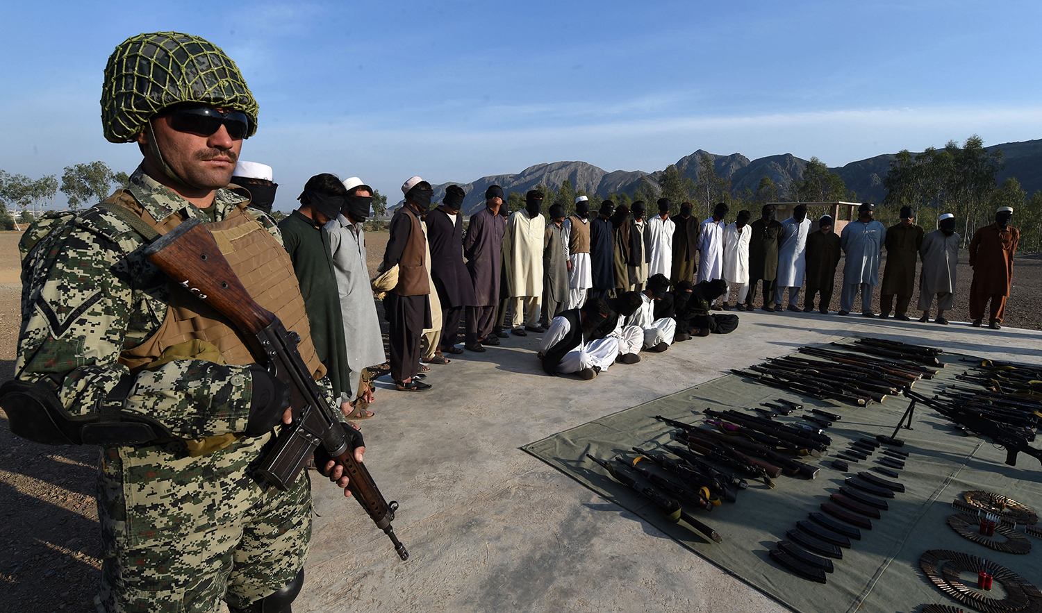 Arrested suspected militants and their recovered weapons are presented to the media by Pakistani paramilitary forces at a security compound in the Jamrud area in Khyber Pakhtunkhwa on March 3, 2017. (AFP/File)