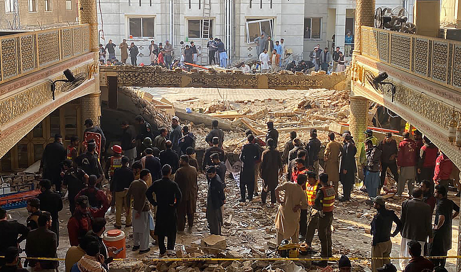 Security officials inspect the site of a mosque blast inside the police headquarters in Peshawar, Pakistan on January 30, 2023. (AFP)