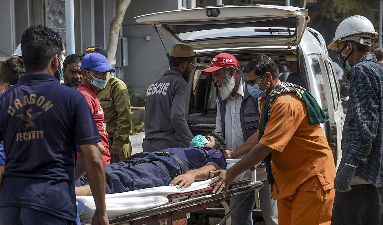 Paramedics personnel shift a patient on a stretcher into the hospital in Karachi on February 18, 2020, after a toxic gas leak in a coastal residential area in Pakistan's port city of Karachi. (AFP/File)