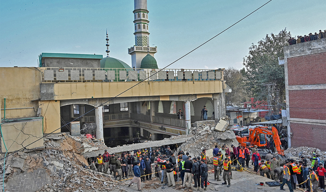 Security personnel and rescue workers prepare to search for the blast victims in the debris of a damaged mosque inside the police headquarters in Peshawar, Pakistan, on January 30, 2023. (AFP)