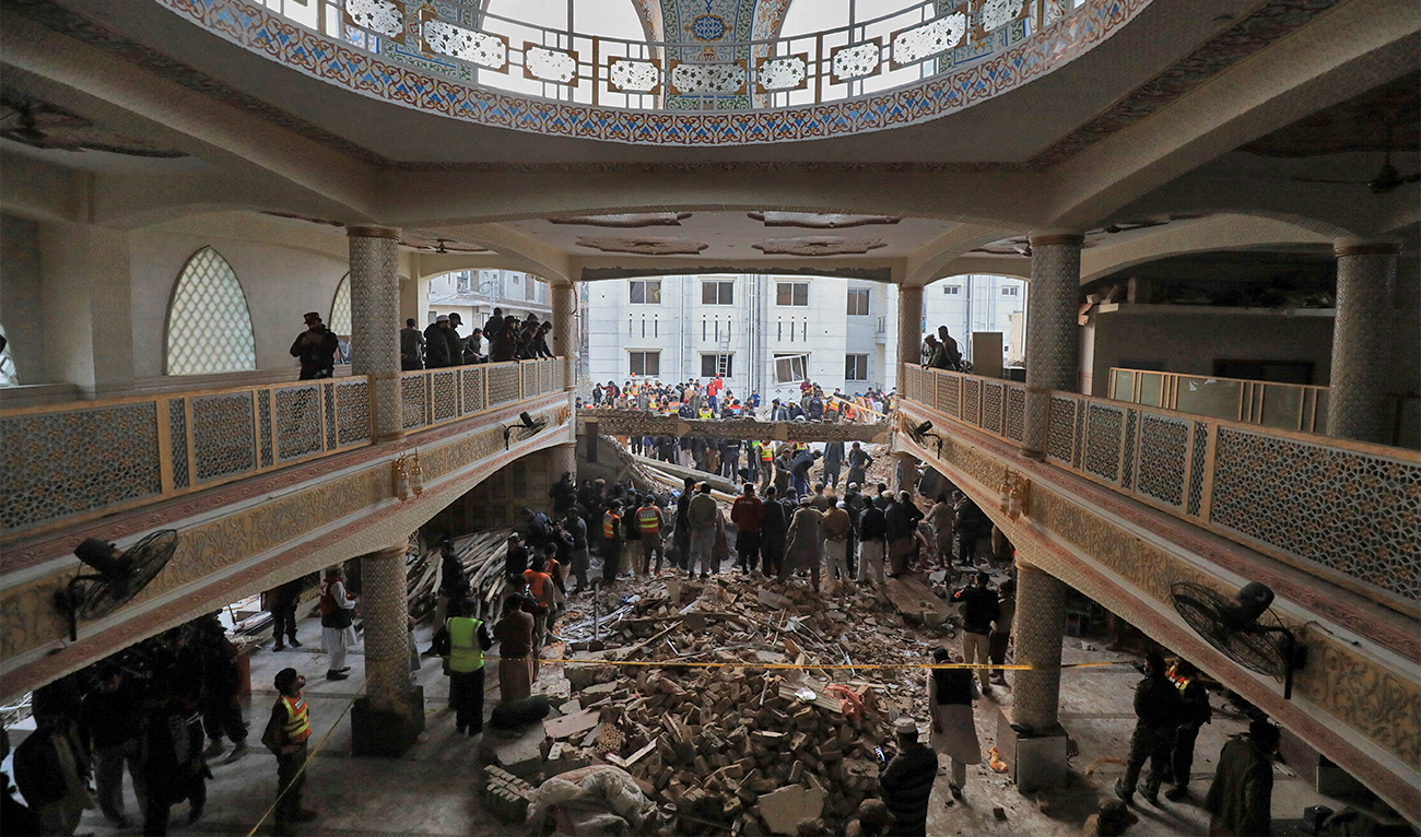 People and rescue workers gather to look for survivors under a collapsed roof, after a suicide blast in a mosque in Peshawar, Pakistan on January 30, 2023. (REUTERS)