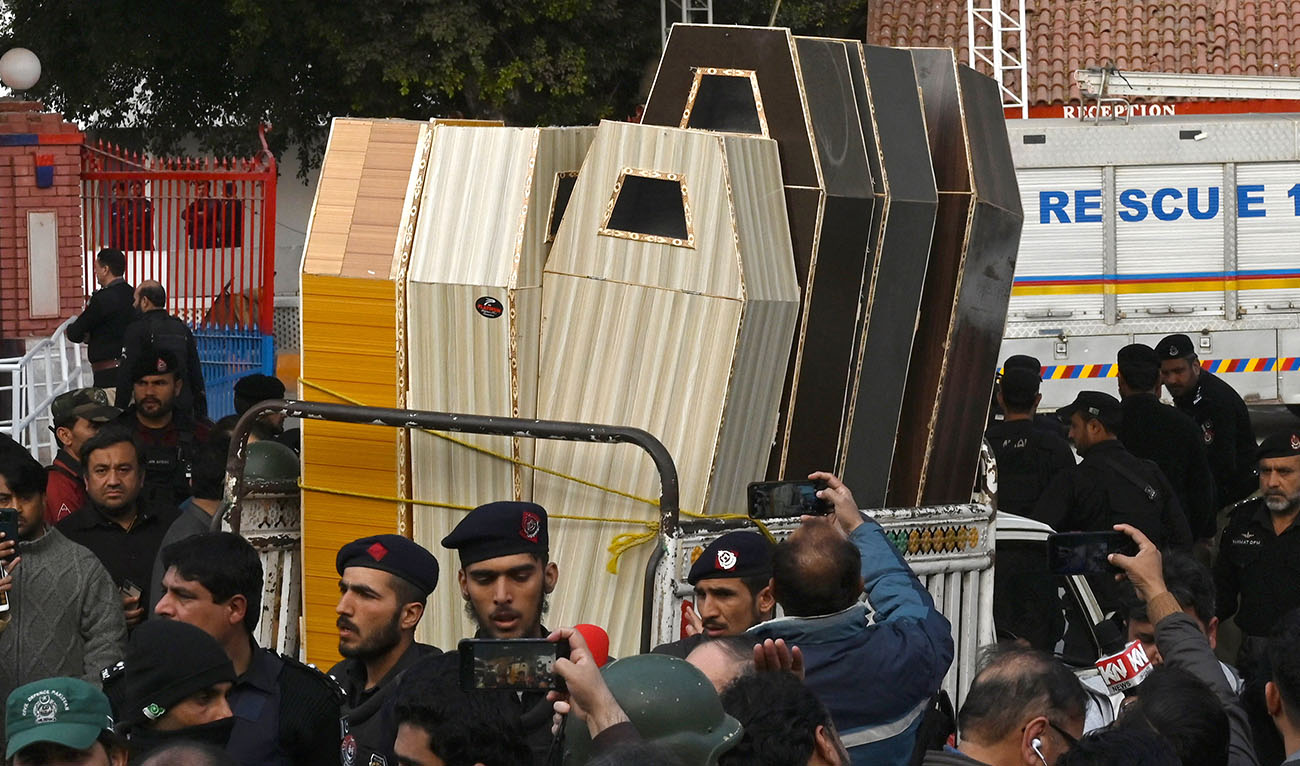 A vehicle transports caskets for bodies of the victims who died in a mosque blast inside the police headquarters in Peshawar on January 30, 2023. (Photo courtesy: AFP)