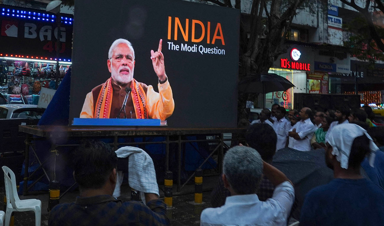 People watch the BBC documentary "India: The Modi Question", on a screen installed at the Marine Drive junction under the direction of the district Congress committee, in Kochi on January 24, 2023. (AFP)