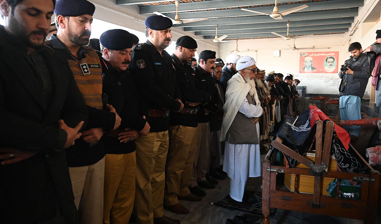 Security officials pray at the funeral of a policeman a day after the mosque blast inside the police headquarters in Peshawar on January 31, 2023. (AFP)