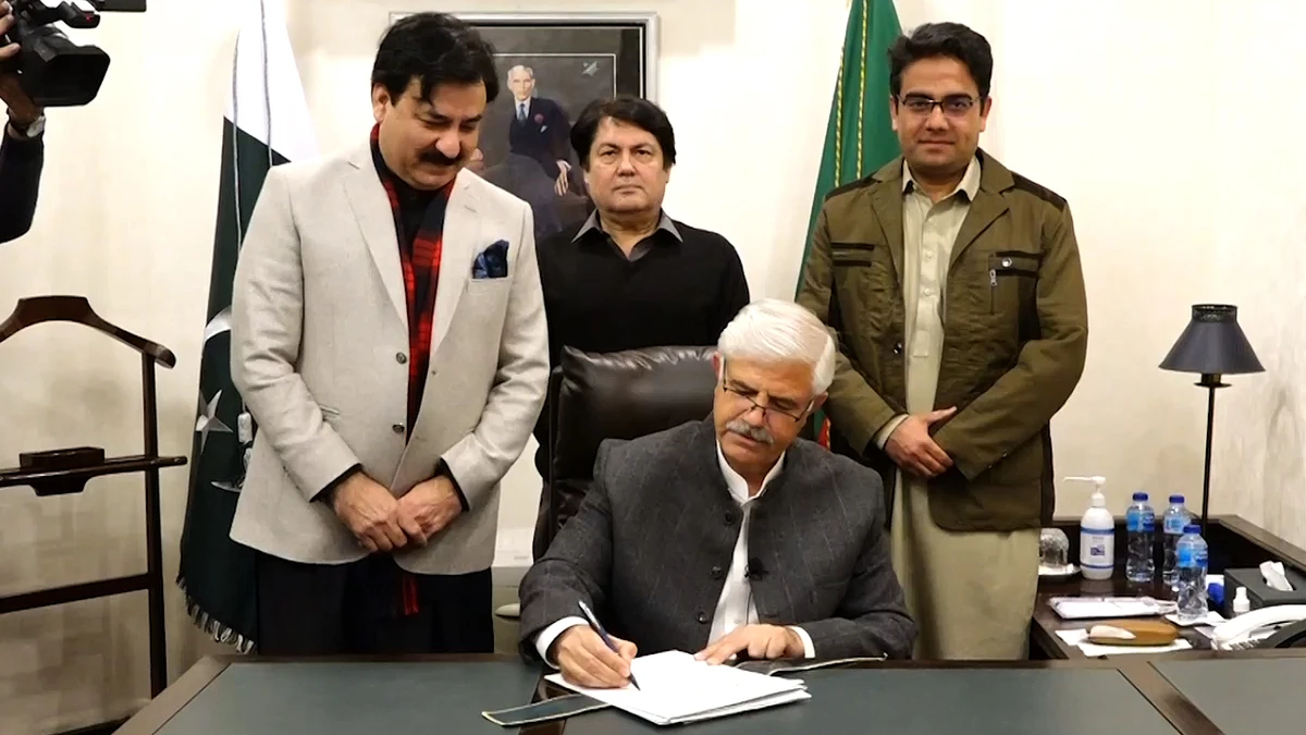 This screengrab shows Khyber Pakhtunkhwa Chief Minister Mahmood Khan while signing the summary for dissolution of the provincial assembly in Peshawar on January 17, 2023. (Courtesy: CM House Khyber Pakhtunkhwa)