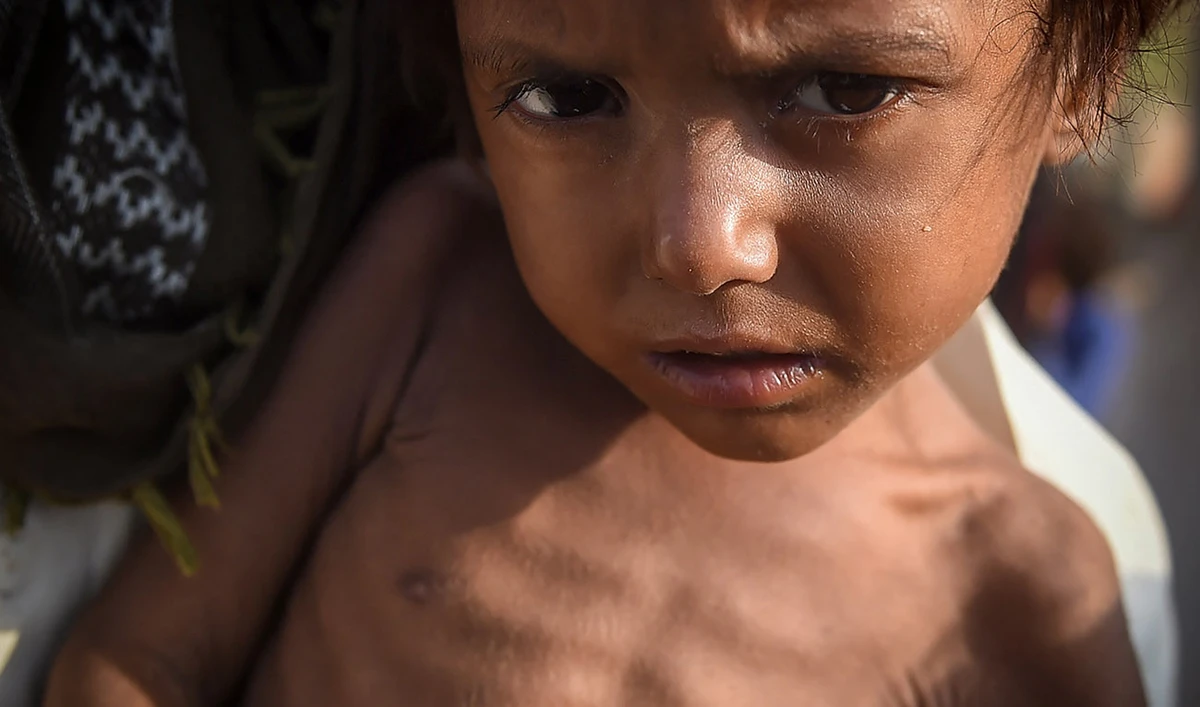 In this picture taken on September 26, 2022, a child belonging to an internally displaced flood-affected man looks on at camp in Jamshoro district of Sindh province, Pakistan. (AFP/FILE)