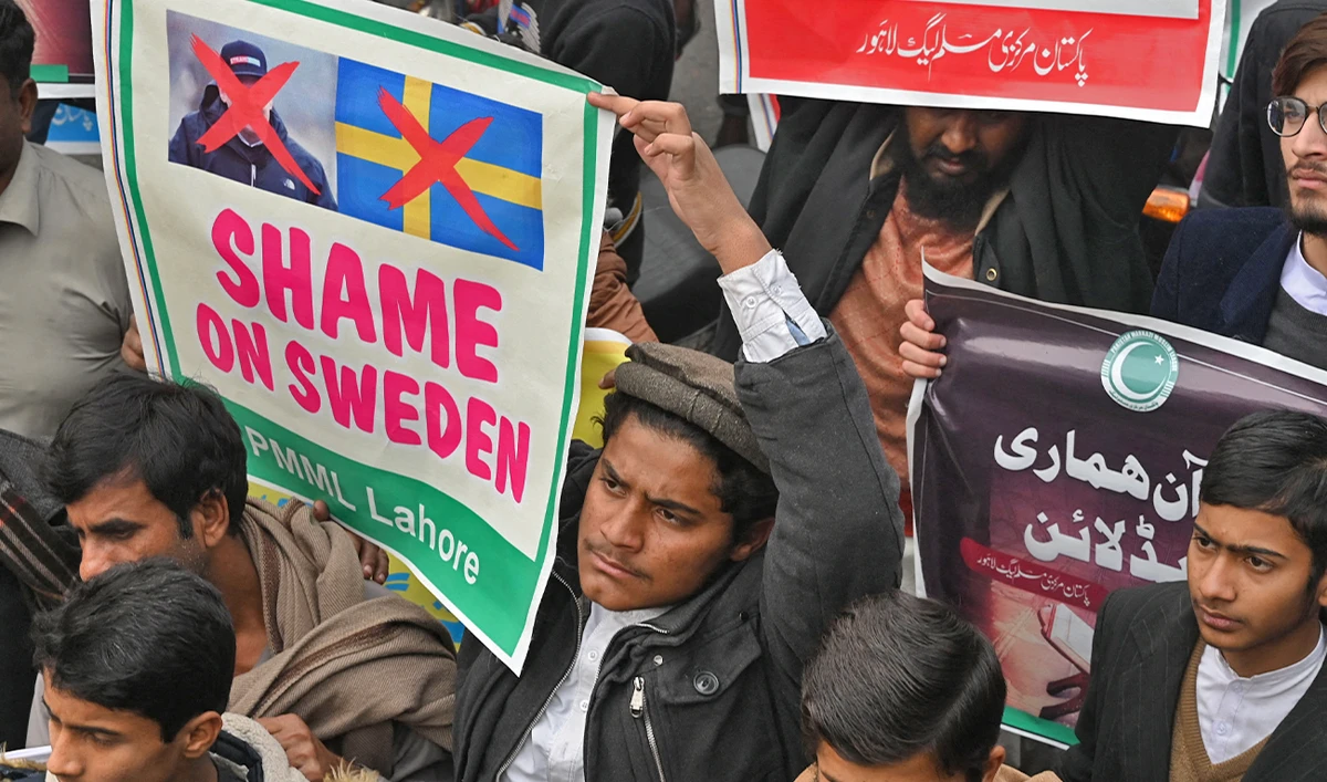 Demonstrators carry placards during a protest against the burning of the Holy Quran in Sweden, in Lahore, Pakistan, on January 24, 2023. (AFP)