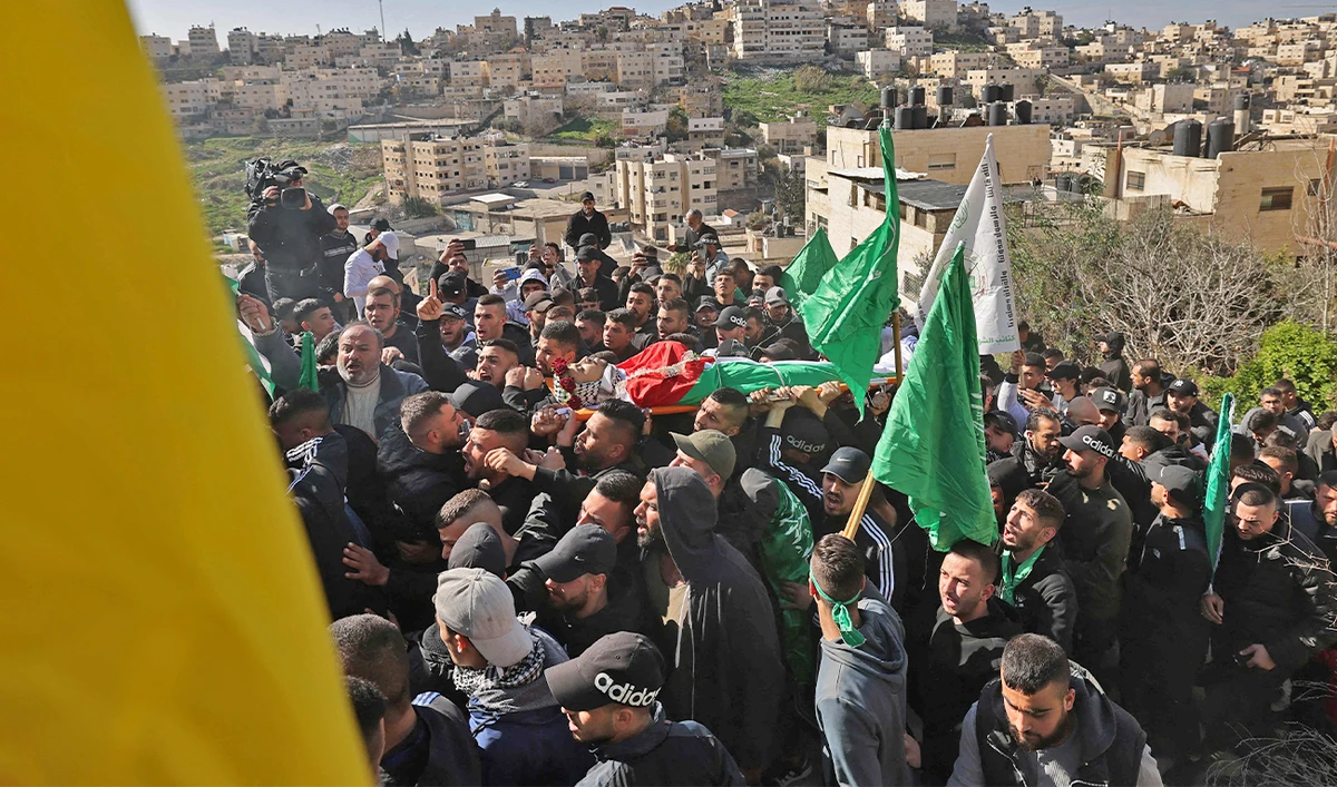 Mourners carry the body of Palestinian youth Yusef Muhaisen, killed by Israeli fire amid clashes, during his funeral in the West Bank town of Al-Ram on January 27, 2023. (AFP)