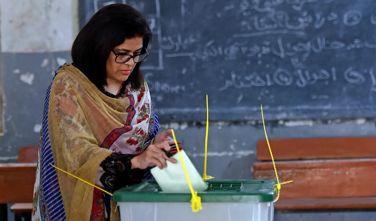 A female voter casts her ballot at a polling station during the by-election for national assembly seats, in Karachi, Pakistan, on October 16, 2022. (AFP/File)
