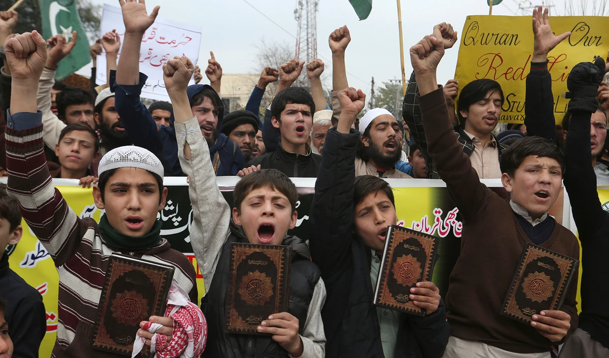 Students chant slogans during a protest to denounce the recent desecration of the Holy Quran by a far-right activist in Sweden, in Peshawar, Pakistan, on January 29, 2023. (AP)