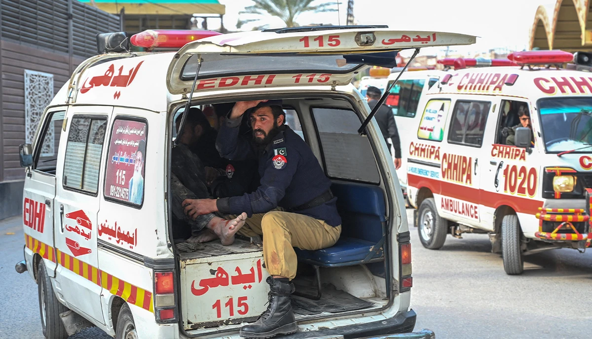 An ambulance transports injured blast victims outside the police headquarters in Peshawar on January 30, 2023. (AFP)