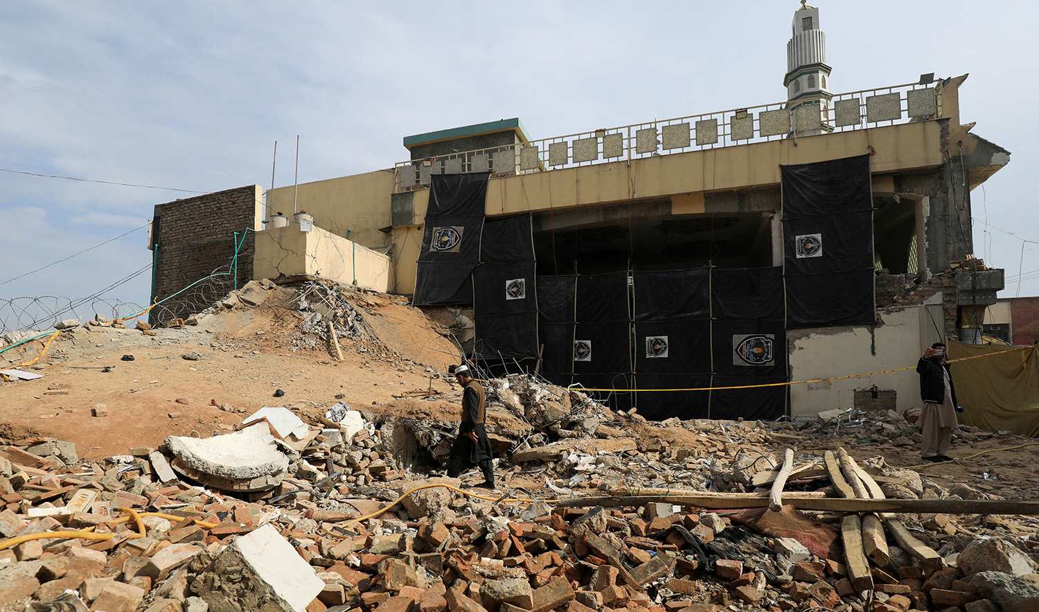 A man walks amid the rubble, days after a suicide blast in a mosque in Peshawar, Pakistan on February 2, 2023. (REUTERS)