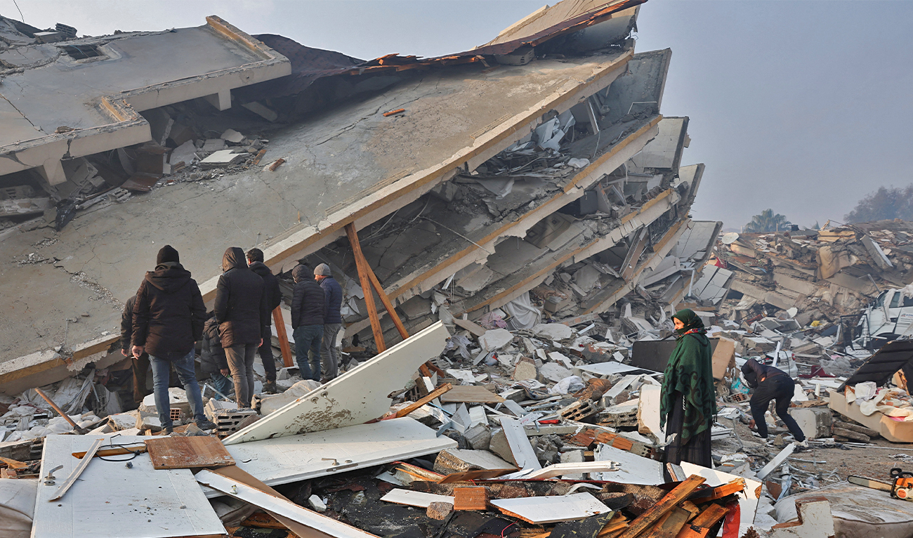 Rescuers search for victims and survivors amidst the rubble of collapsed buildings in Kahramanmaras, Turkey, after a 7.8-magnitude earthquake struck the country's southeast on February 7, 2023. (AFP)