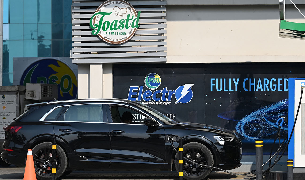 An electic car is being charged at a charging station in Islamabad on February 16, 2022. (Photo courtesy: AFP)
