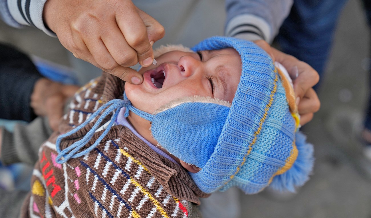 A health worker administers a polio vaccine to a child in Lahore, Pakistan, on February 13, 2023. (AP)