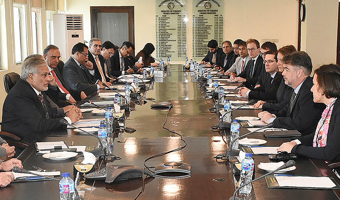 This handout photograph released by the Pakistan Press Information Department (PID) on January 31, 2023, shows Pakistan’s Finance Minister Ishaq Dar (L) meeting with a International Monetary Fund (IMF) review mission led by IMF mission official Nathan Porter (2R) at the Finance Ministry in Islamabad. (Photo courtesy: PID)