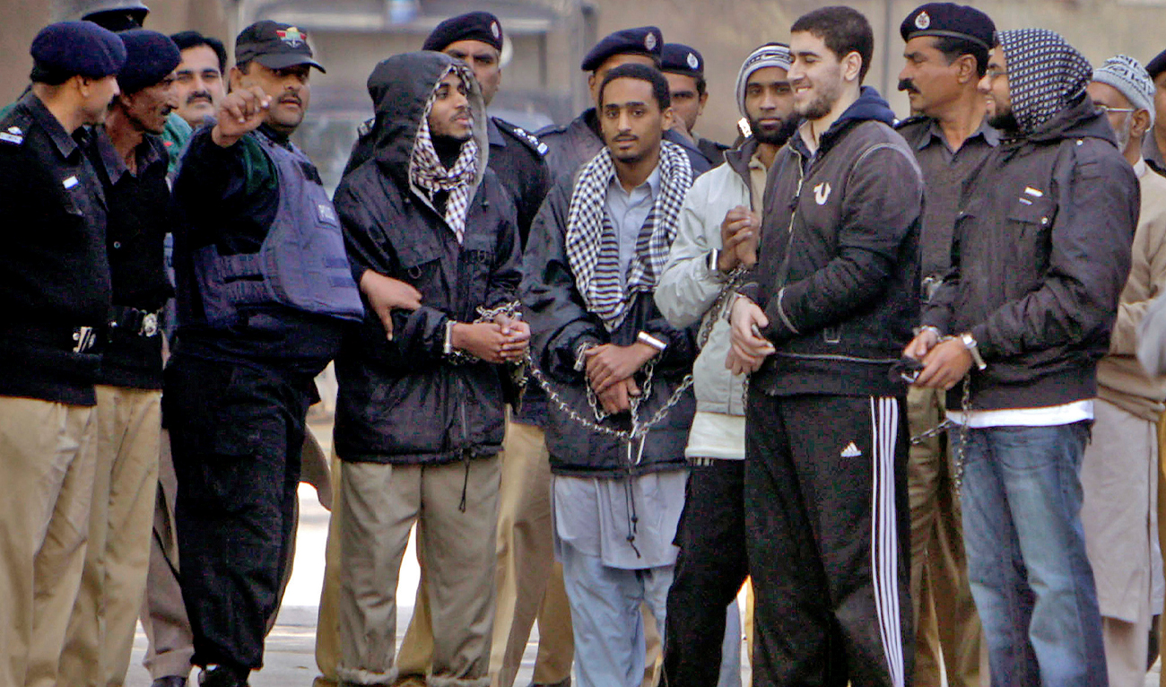 Detained American Muslims, center, are escorted by Pakistan police officers as they leave after appear in an anti terrorist court in Sargodha, Pakistan, on January 4, 2010. (AP/File)