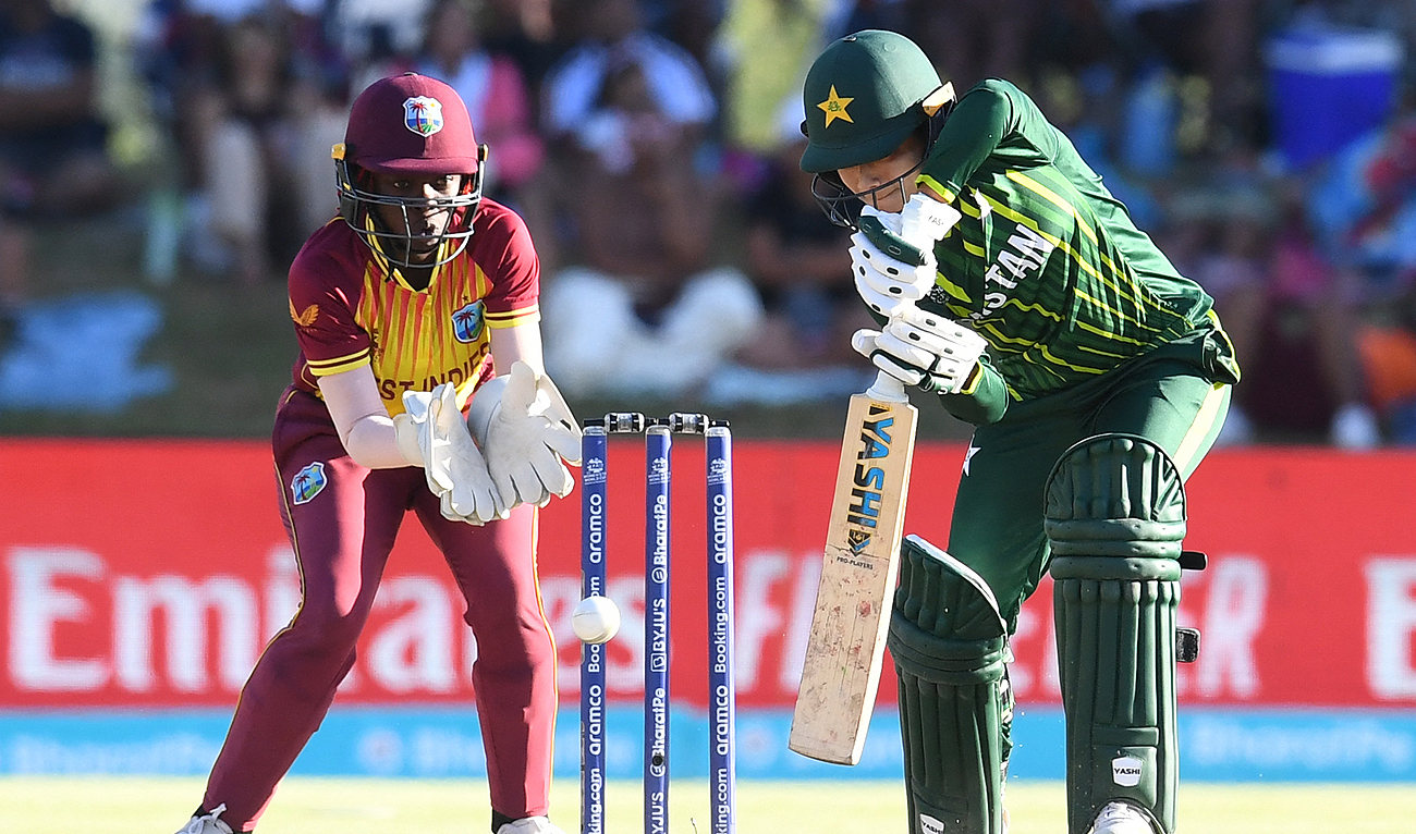 Pakistan's Fatima Sana (R) plays a shot as West Indies' wicketkeeper Rashada Williams (R) looks on during the Group B T20 women's World Cup cricket match between Pakistan and West Indies at Boland Park in Paarl on February 19, 2023. (Photo courtesy: AFP)