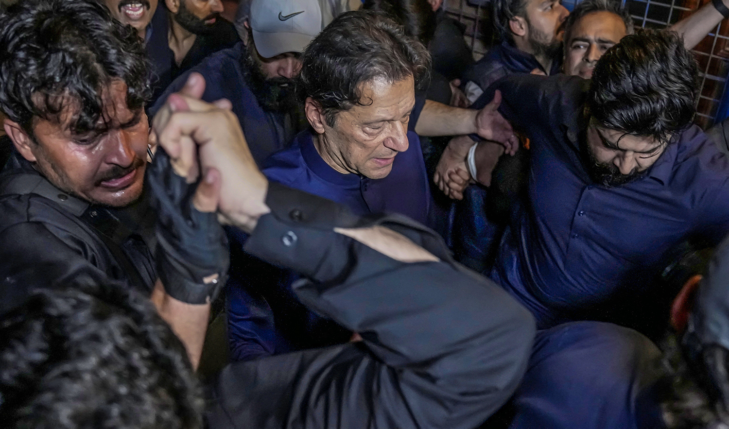 Pakistan's former Prime Minister, Imran Khan, along with his supporters walks as he leaves the district High Court in Lahore, Pakistan on February 20, 2023. (REUTERS)