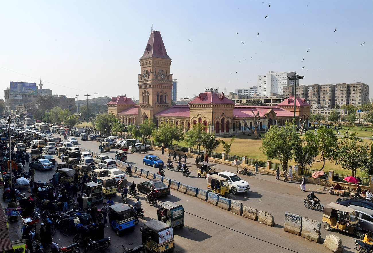 This picture taken on January 30, 2023 shows commuters passing Impress Market in Pakistan's port city of Karachi. (AFP/File)
