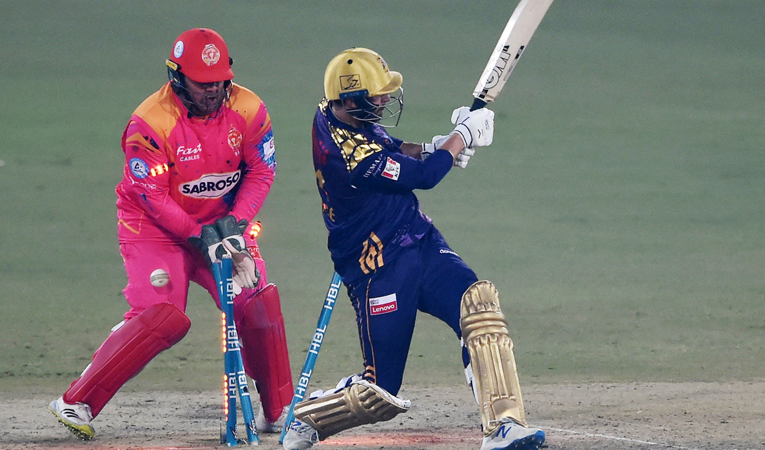 Islamabad United's wicketkeeper Azam Khan (L) reacts as Quetta Gladiators' batsman James Vince (R) is bowled during the Pakistan Super League (PSL) Twenty20 cricket match at The Gaddafi Cricket Stadium in Lahore on February 12, 2022. (AFP/File)