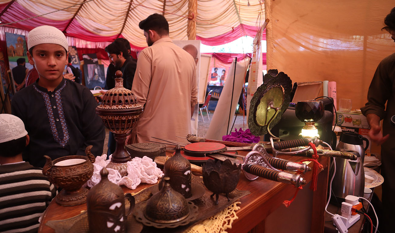 A young boy visits the desk of antique itmes of Arabic Culture at University of Peshawar on February 24, 2023. (AN Photo)