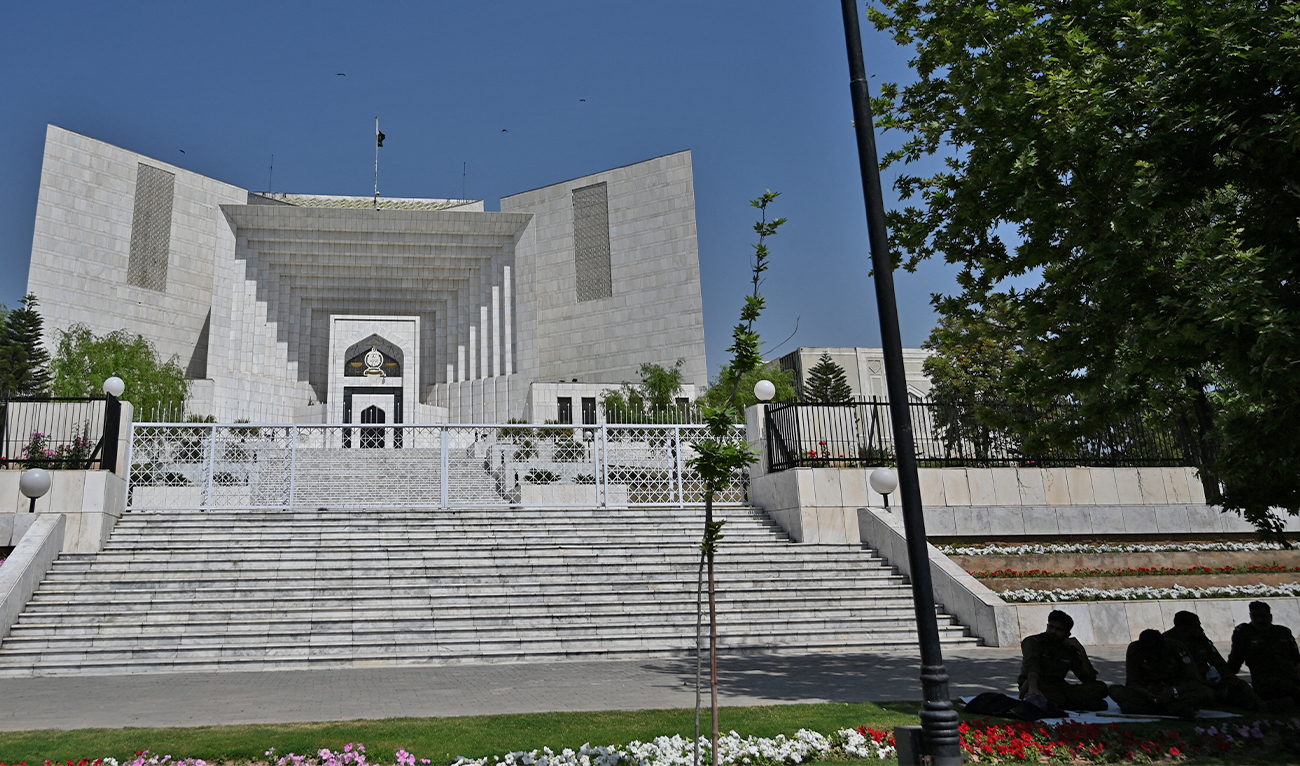 Policemen sit beside the Pakistan's Supreme Court building during a hearing in Islamabad on April 6, 2022. (AFP/File)