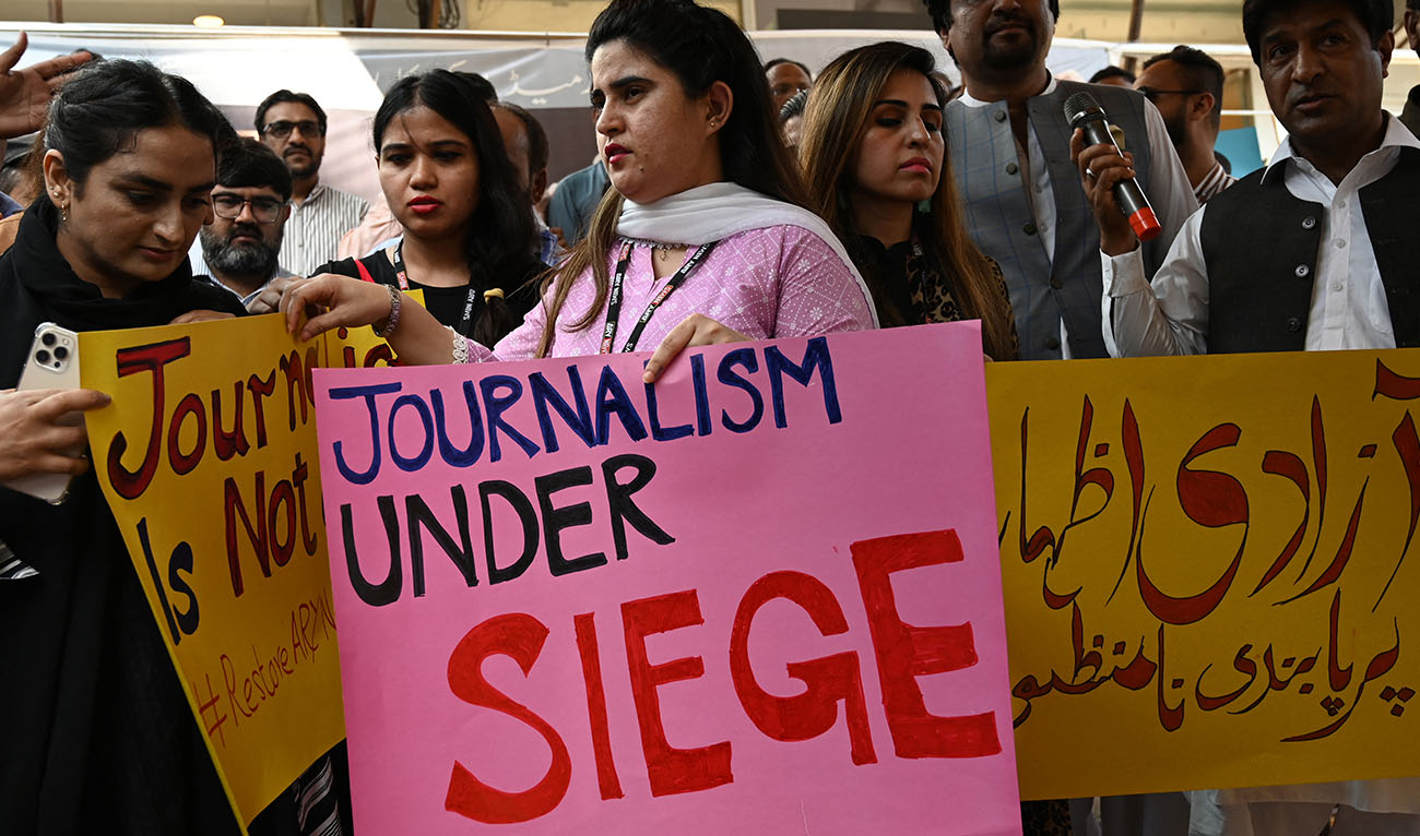 Journalists and employees of ARY News, a private news channel, hold placards during a protest against the channel being taken off air by the government in Islamabad on August 12, 2022. (AFP/FILE)