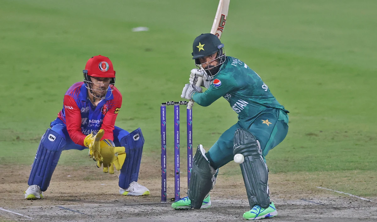 Pakistan's Shadab Khan (R) plays a shot during the Asia Cup Twenty20 international cricket Super Four match between Afghanistan and Pakistan at the Sharjah Cricket Stadium in Sharjah, UAE, on September 7, 2022. (AFP/File)