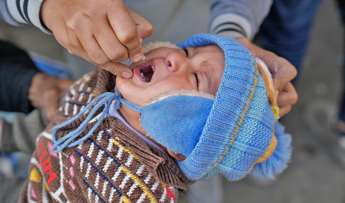 A health worker administers a polio vaccine to a child in Lahore, Pakistan, on February 13, 2023. (AP)