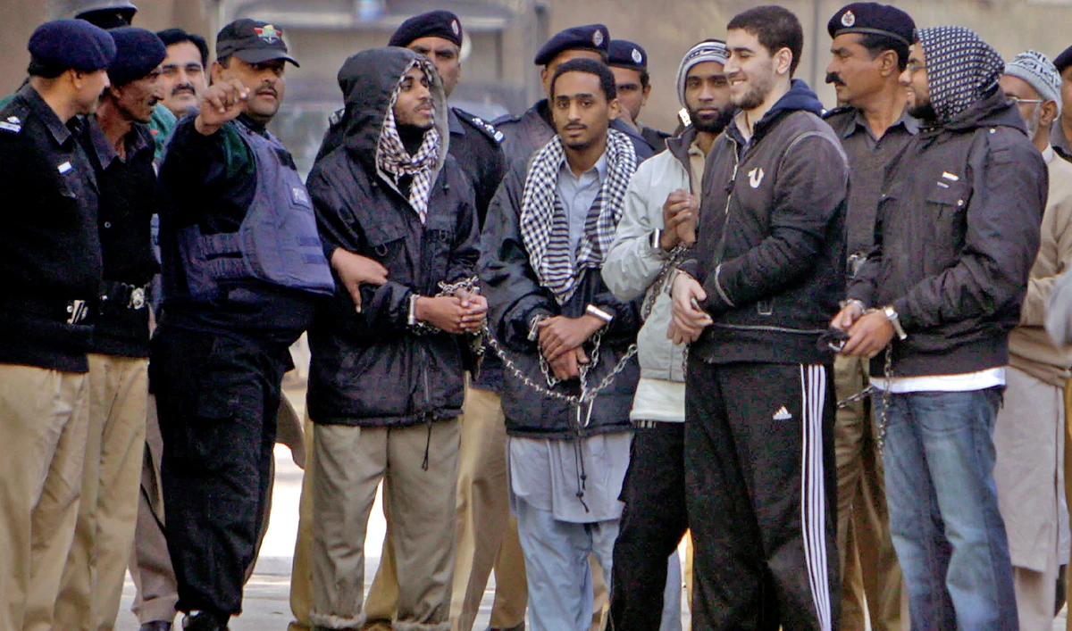 Detained American Muslims, center, are escorted by Pakistan police officers as they leave after appear in an anti terrorist court in Sargodha, Pakistan, on January 4, 2010. (AP/File)