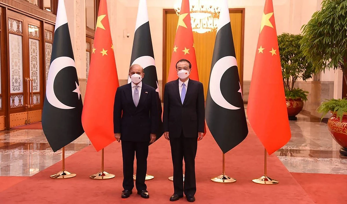 This handout picture taken and released by the Pakistan Prime Minister Office on November 2, 2022, shows Pakistan Prime Minister Shahbaz Sharif (L) and China's Premier Li Keqiang (R) posing for a photograph prior to their talks at the Great Hall of the People in Beijing, China. (Photo courtesy: Pakistan Prime Minister Office/AFP/FILLE)