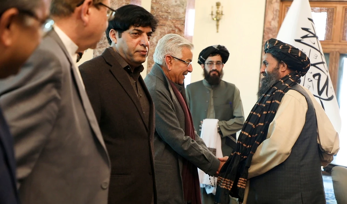 Mullah Abdul Ghani Baradar, the Taliban-appointed deputy prime minister for economic affairs, right, shakes hands with Pakistan's defense minister, Khawaja Mohammad Asif, during a meeting in Kabul, Afghanistan, on February 22, 2023. (Deputy Prime Minister Minister Office via AP)