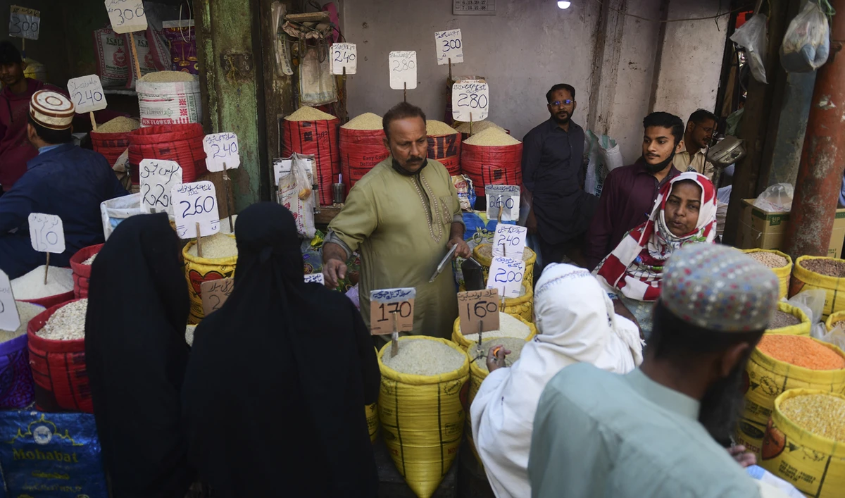 People buy rice at a market in Karachi on February 3, 2023. (Photo courtesy: AFP/File)