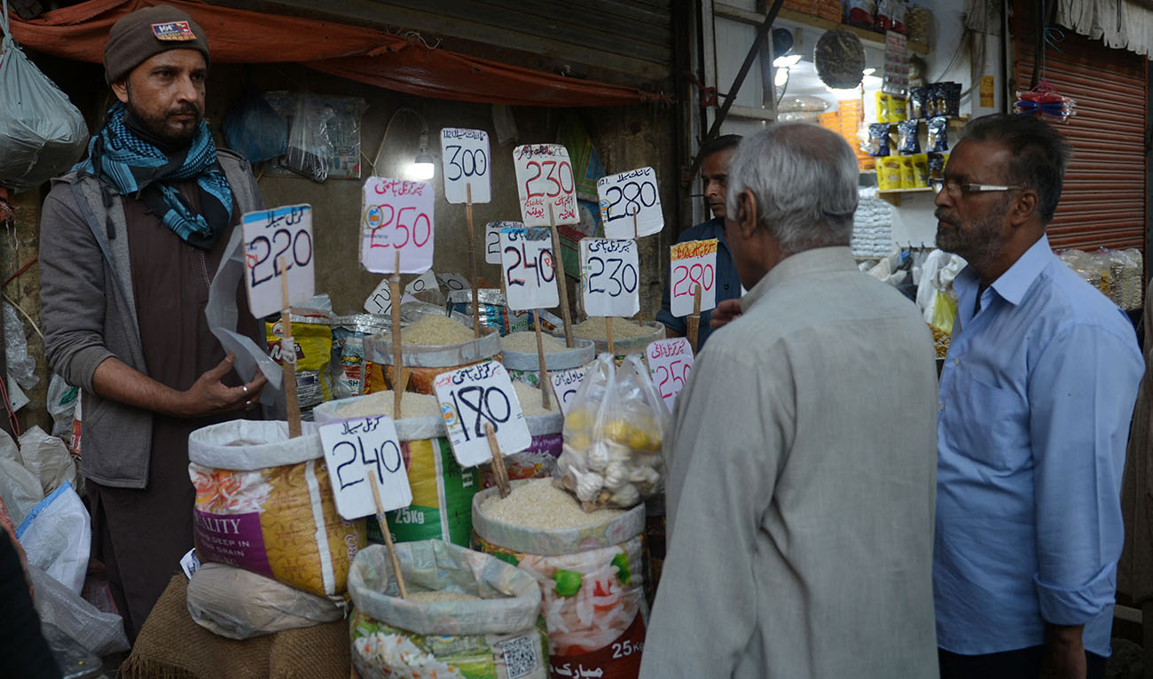 People buy rice at a wholesale market in Karachi on February 1, 2023. (Photo courtesy: AFP)