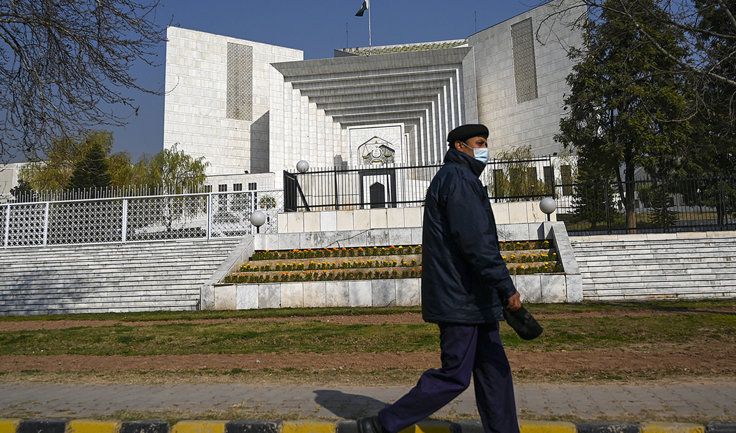 A policeman walks past the Supreme Court building in Islamabad, Pakistan, on January 29, 2021. (AFP/File)