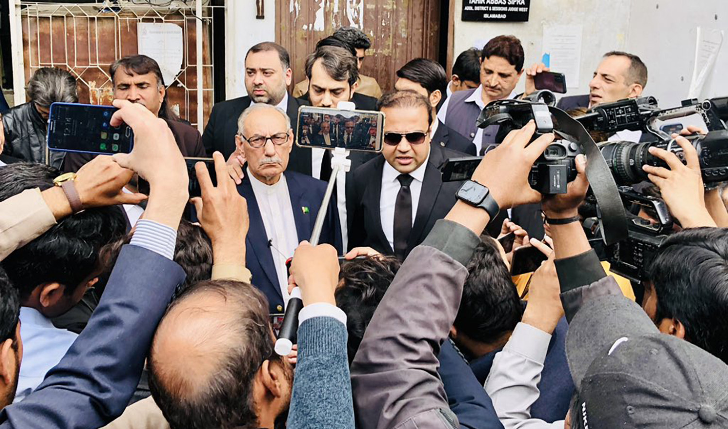 Lieutenant General Amjad Shoaib, center left, with lawyer Mian Ali Ashfaq, center right, after he was discharged by a court in Pakistan's capital Islamabad in 'public mischief' case on March 2, 2023. (Photo courtesy: @MianAliAshfaq/Twitter)